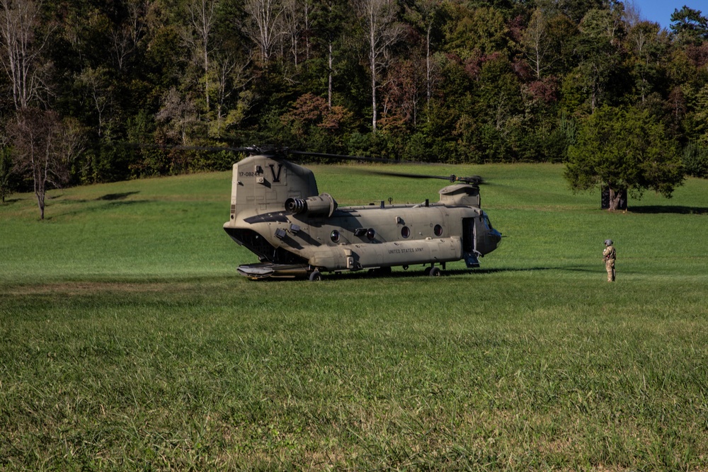 A U.S. Army CH-47 “Chinook” helicopter and its crew prepare to take-off from a campsite in response to Hurricane Helene