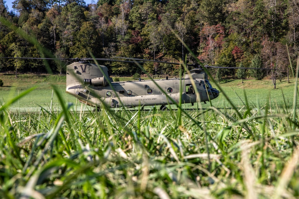 A U.S. Army CH-47 “Chinook” helicopter and its crew prepare to take-off from a campsite in response to Hurricane Helene