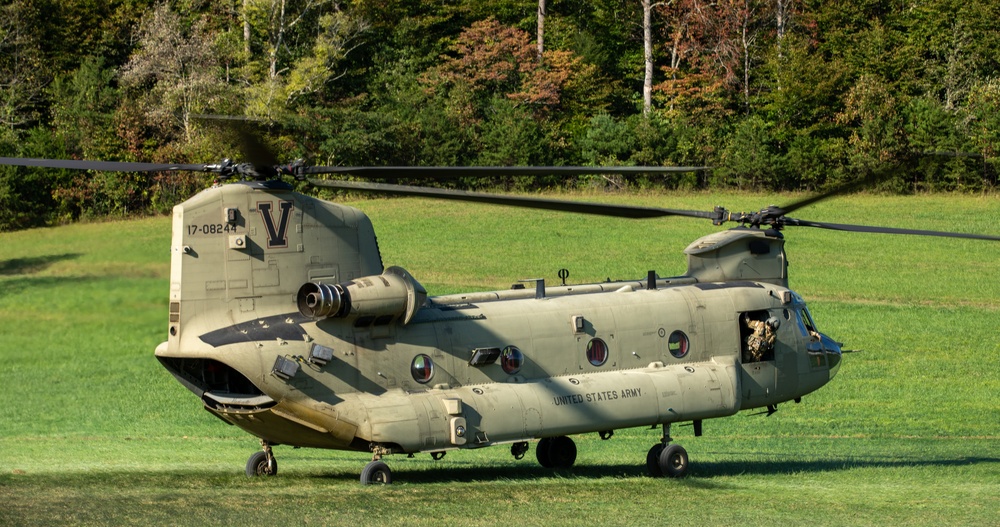 A U.S. Army CH-47 “Chinook” helicopter and its crew prepare to take-off from a campsite