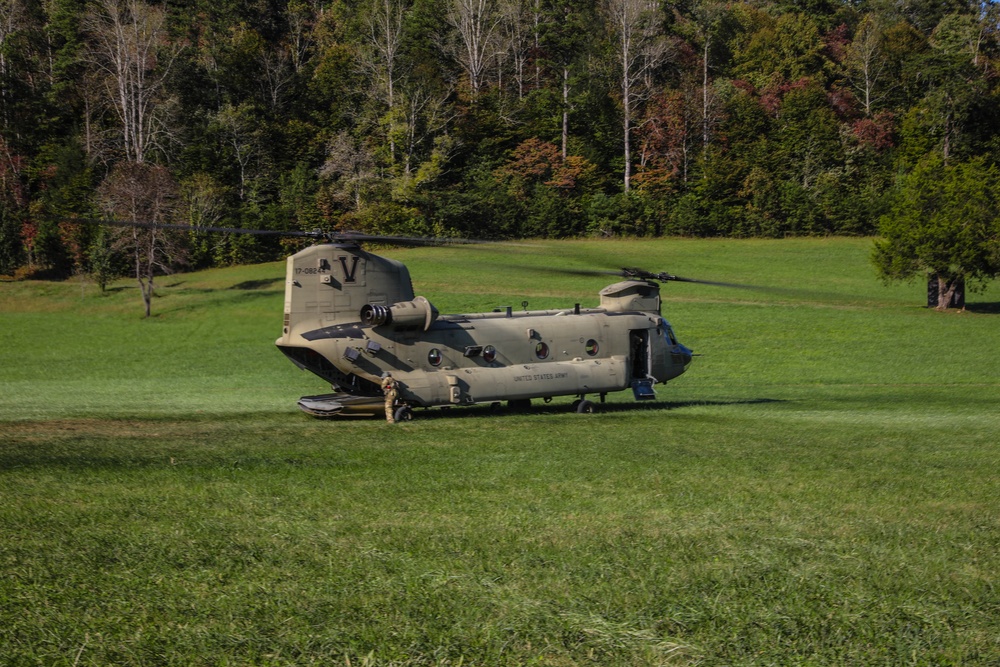 A U.S. Army CH-47 “Chinook” helicopter and its crew prepare to take-off from a campsite in response to Hurricane Helene