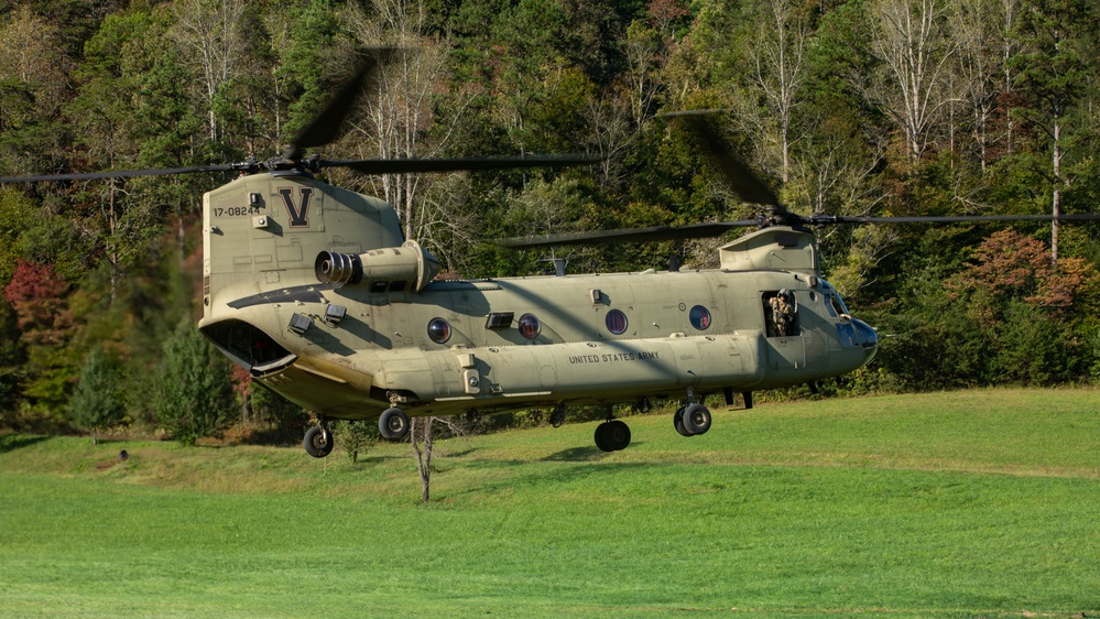 A U.S. Army CH-47 “Chinook” helicopter and its crew prepare to take-off from a campsite