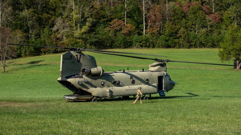 A U.S. Army CH-47 “Chinook” helicopter and its crew prepare to take-off from a campsite