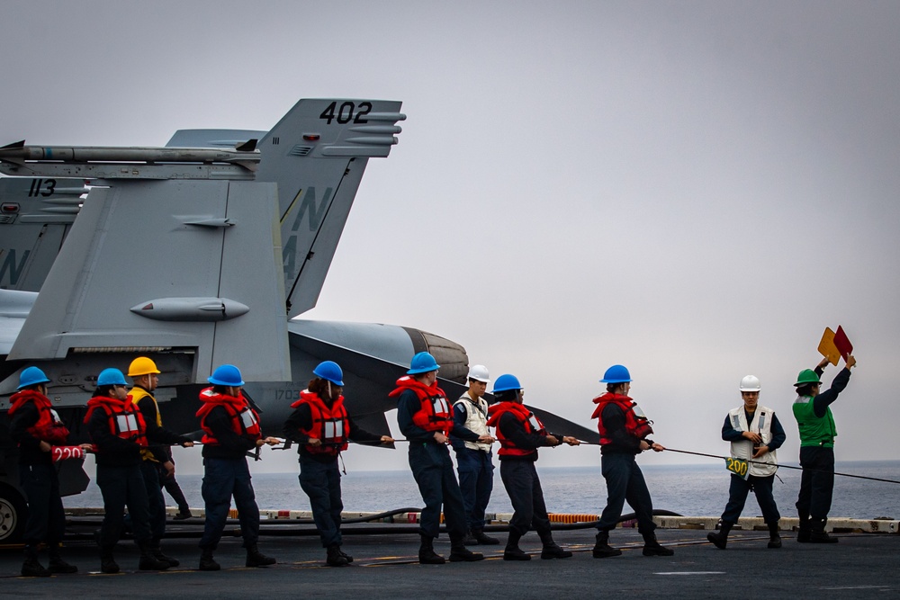 Nimitz Sailors Hold Phone and Distance Line
