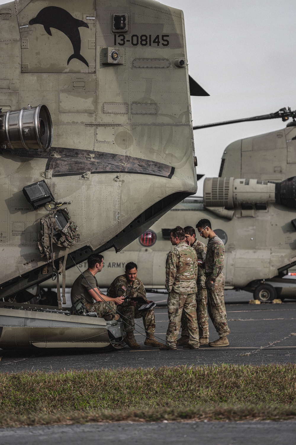 U.S. Army Soldiers, from the 82nd Airborne Division, prepare to board a CH-47 for deployment and distribution of food and supplies in support of Hurricane Helene relief efforts