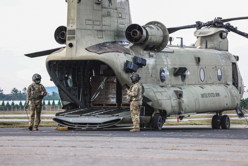 U.S. Army Soldiers, from the 82nd Airborne Division, prepare to board a CH-47 for deployment and distribution of food and supplies in support of Hurricane Helene relief efforts