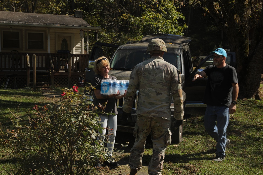 U.S. Army Soldiers, in support of FEMA during Hurricane Helene, deliver food, and water to civilians in need