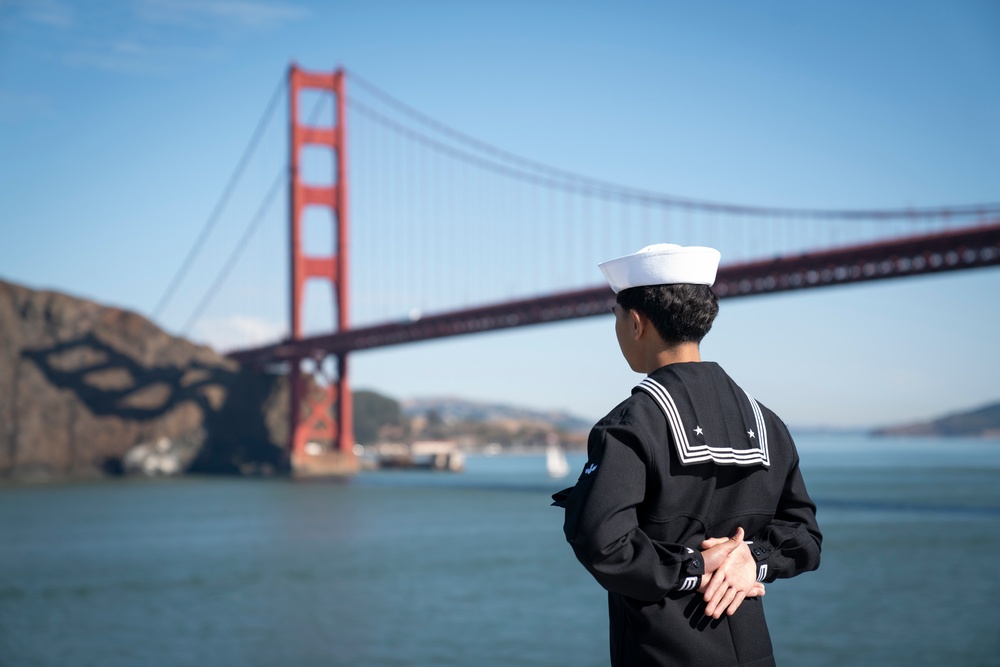 USS Tripoli Sailors man the rails while pullinig in to San Francisco