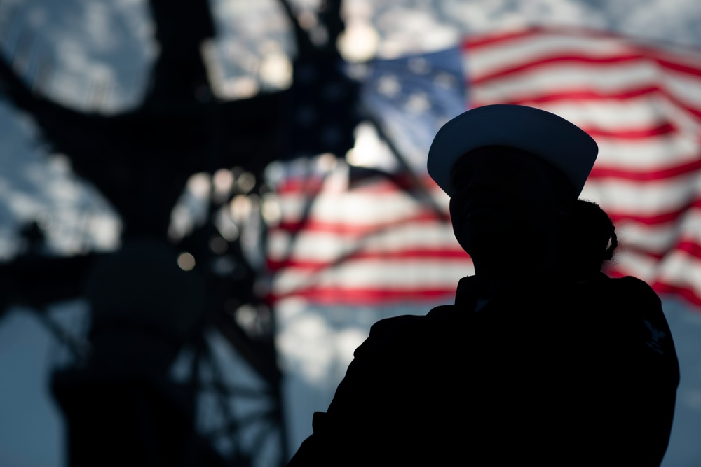 USS Tripoli Sailors man the rails while pulling into San Francisco