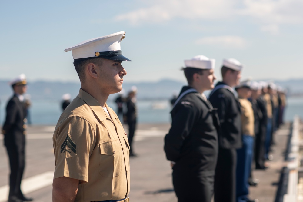 USS Tripoli Sailors man the rails while pulling into San Francisco