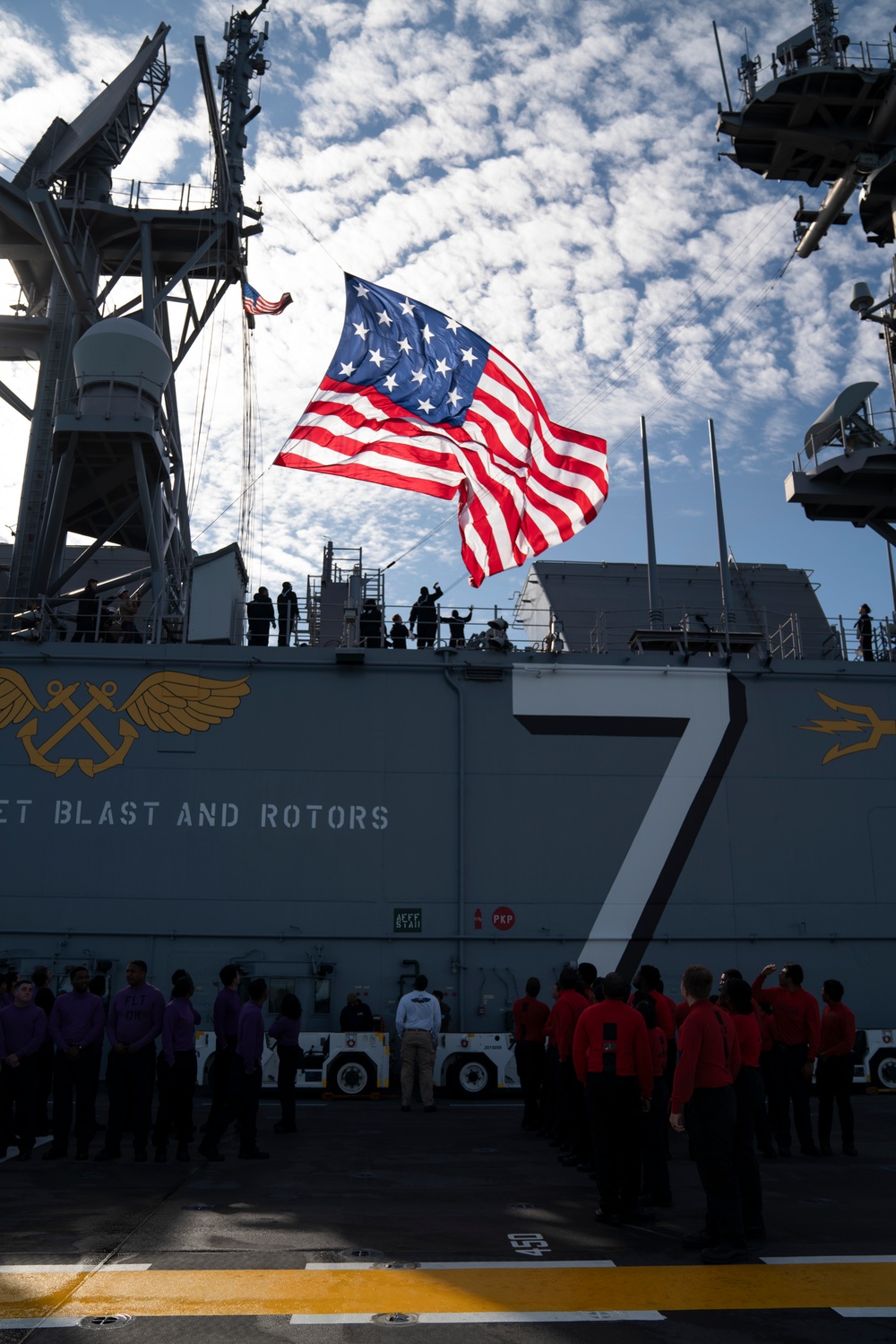 USS Tripoli Sailors man the rails while pullinig in to San Francisco