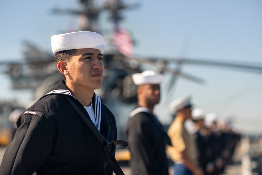 USS Tripoli Sailors man the rails while pulling into San Francisco