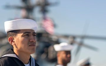 USS Tripoli Sailors man the rails while pulling into San Francisco