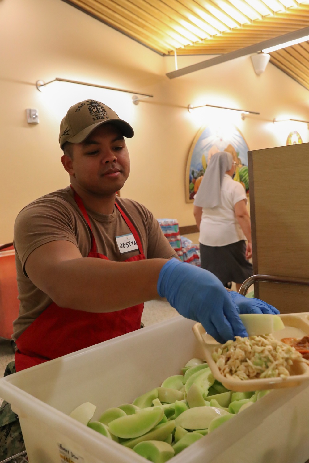 USS Tripoli sailors serve food at Saint Anthoneys