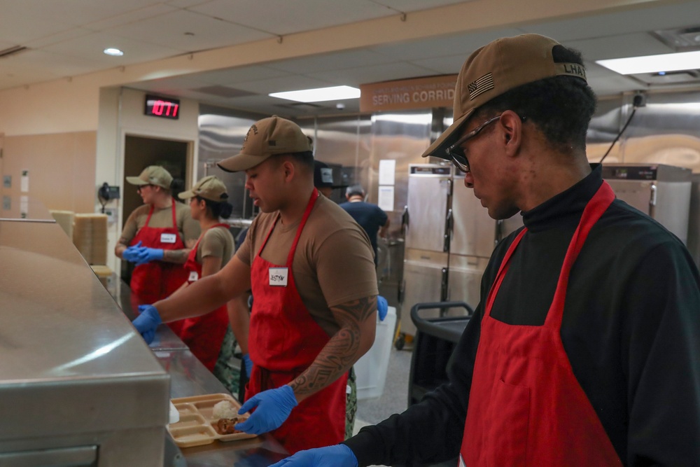 USS Tripoli sailors serve food at Saint Anthoneys