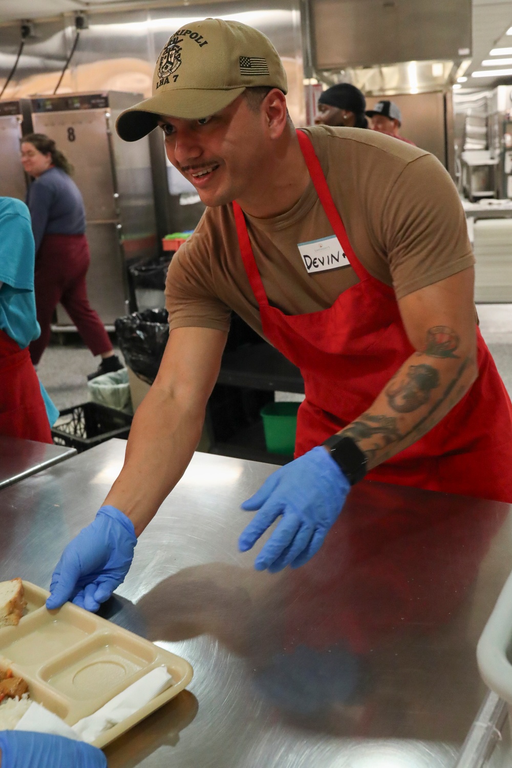 USS Tripoli sailors serve food at Saint Anthoneys