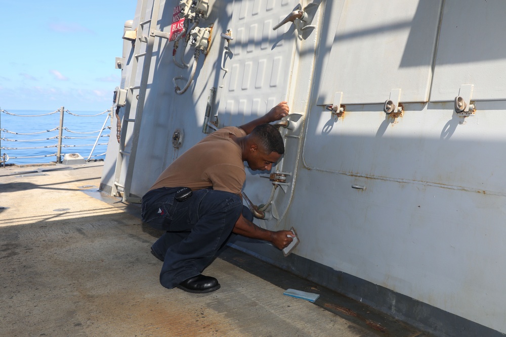 Sailors aboard the USS Howard conduct ship preservation efforts in the South China Sea