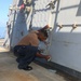 Sailors aboard the USS Howard conduct ship preservation efforts in the South China Sea