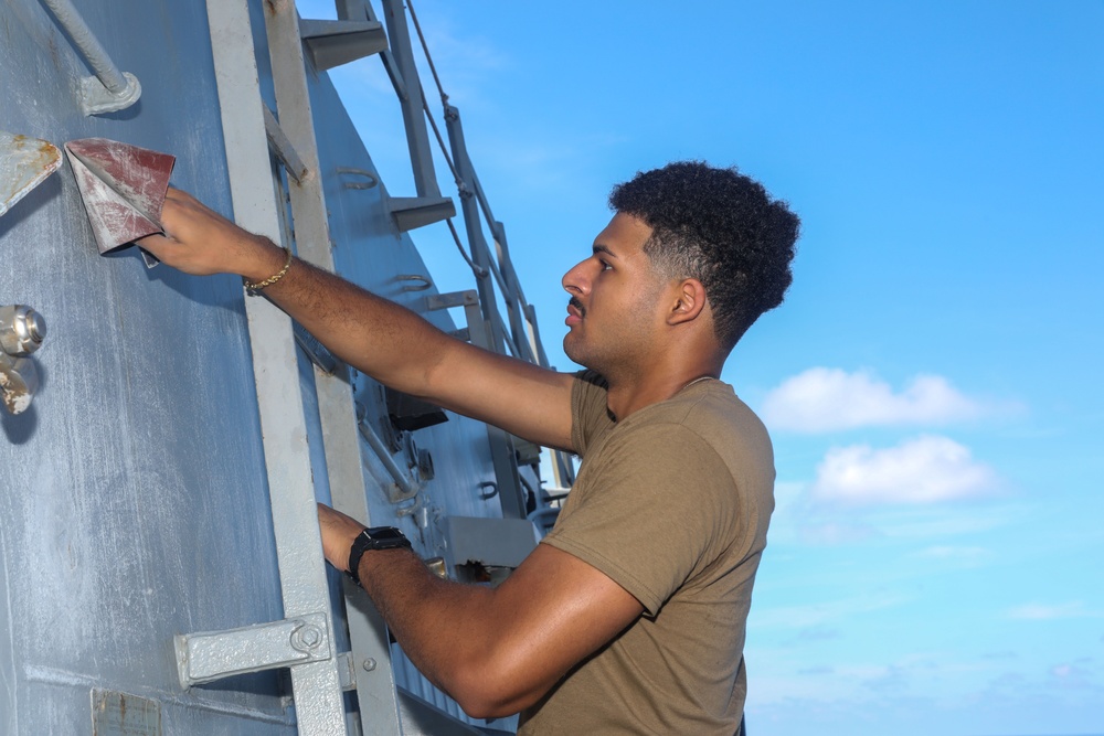 Sailors aboard the USS Howard conduct ship preservation efforts in the South China Sea