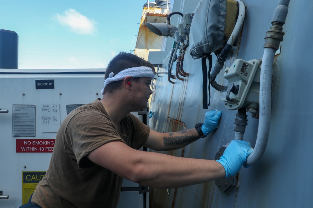 Sailors aboard the USS Howard conduct ship preservation efforts in the South China Sea