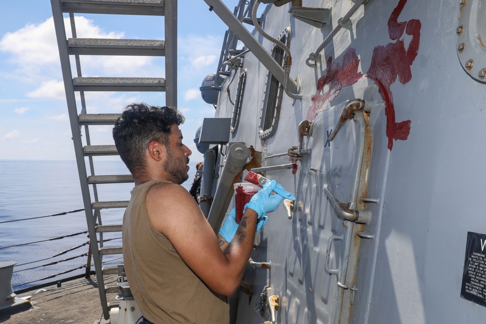 Sailors aboard the USS Howard conduct ship preservation efforts in the South China Sea