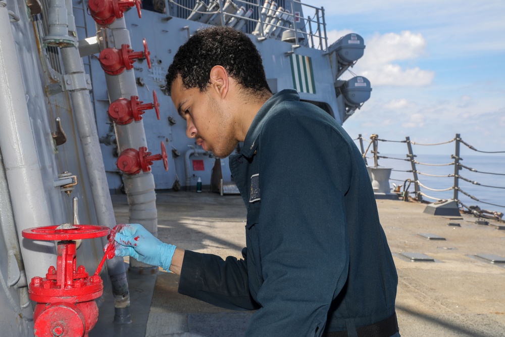 Sailors aboard the USS Howard conduct ship preservation efforts in the South China Sea