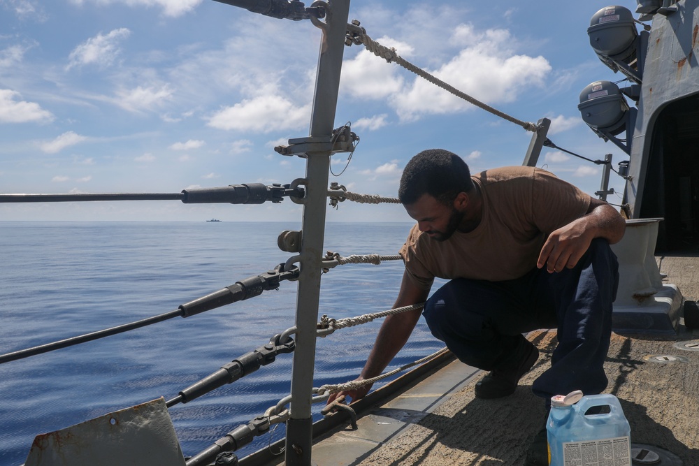 Sailors aboard the USS Howard conduct ship preservation efforts in the South China Sea