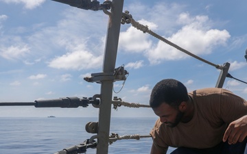 Sailors aboard the USS Howard conduct ship preservation efforts in the South China Sea