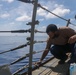 Sailors aboard the USS Howard conduct ship preservation efforts in the South China Sea