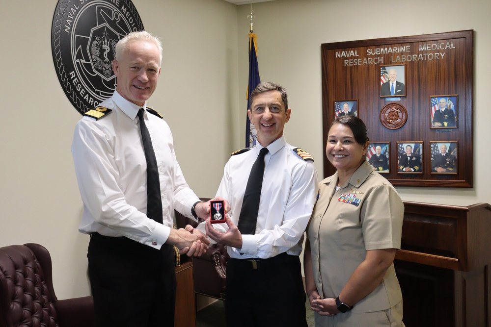 Royal Navy Commodore Presents UK Coronation Medal to NSMRL Exchange Officer