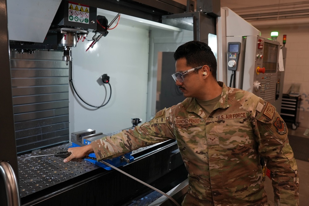 Aircraft Metals Technology Specialists operate computer numerical control machine