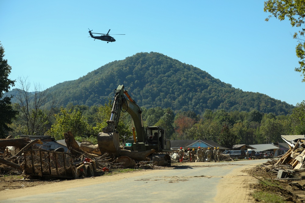 Guardsmen work together to clear debris in Bumpus Cove, Tennessee