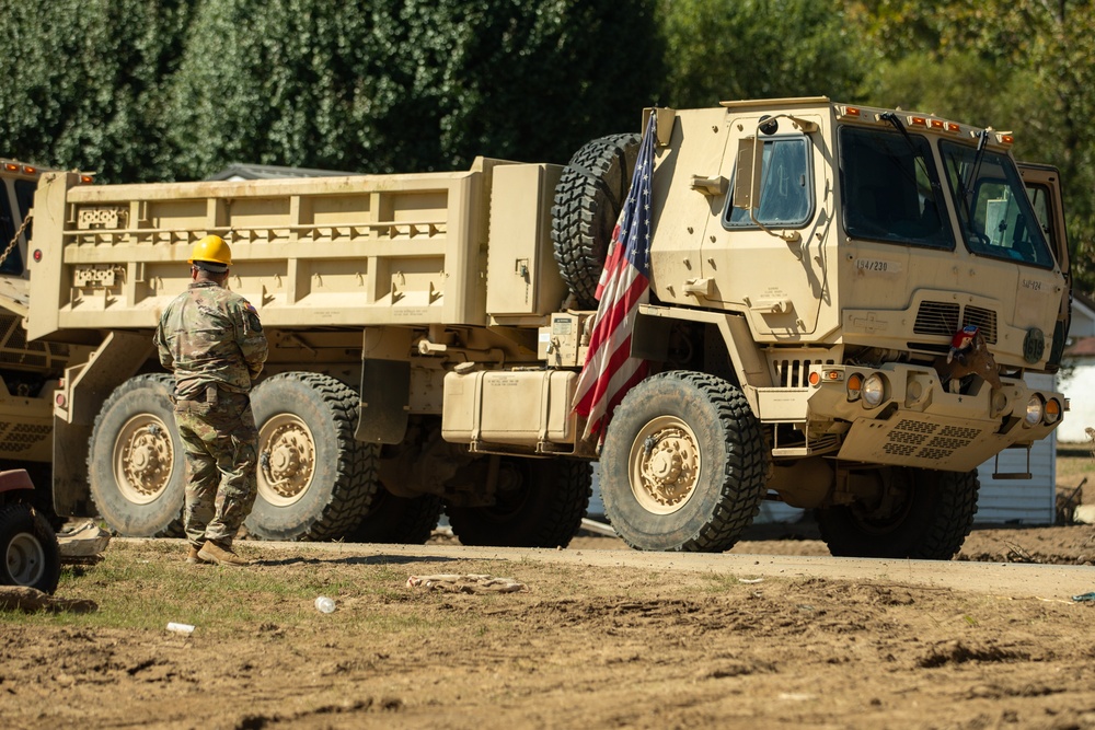 Guardsmen work together to clear debris in Bumpus Cove, Tennessee