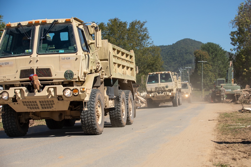 Guardsmen work together to clear debris in Bumpus Cove, Tennessee