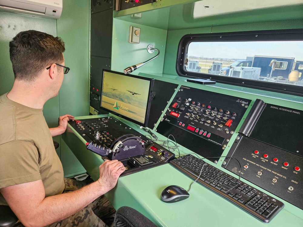 Airmen install propeller on jet engine test stand