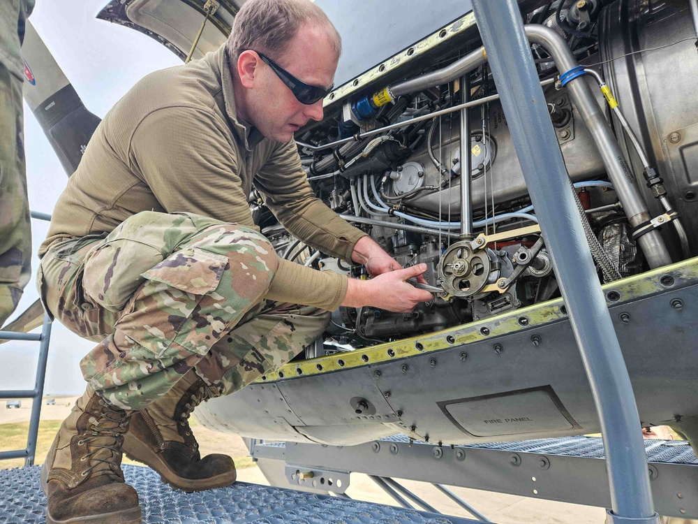 Airmen install propeller on jet engine test stand