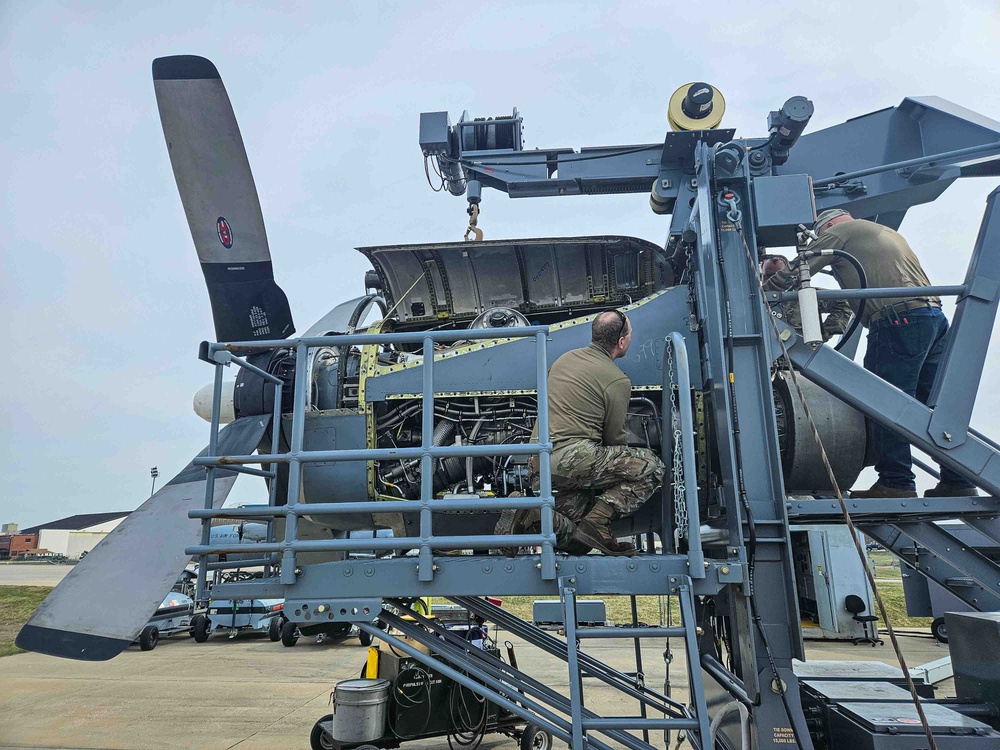 Airmen install propeller on jet engine test stand