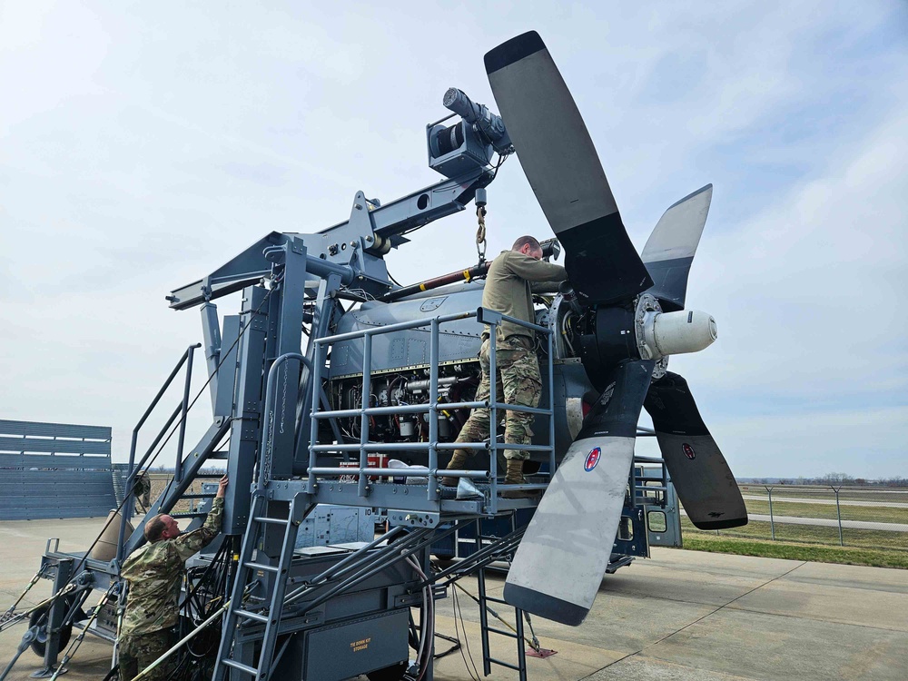 Airmen install propeller on jet engine test stand