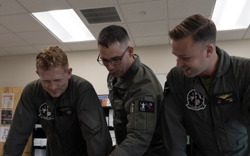 U.S. Marines with Marine Aerial Refueler Transport Squadron (VMGR) 252 conduct mission planning