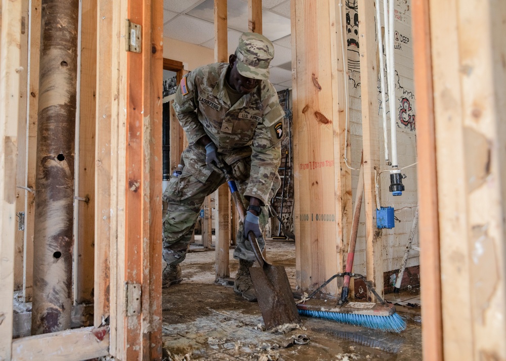 2nd Brigade, 502nd Infantry Regiment scrapes mud off of storefronts