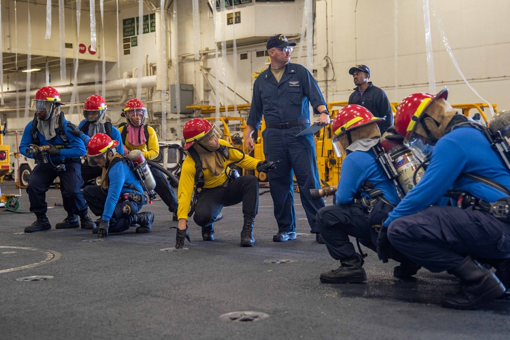 USS Ronald Reagan (CVN 76) Sailors conduct training during a general quarters drill