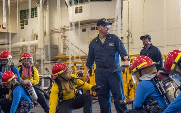 USS Ronald Reagan (CVN 76) Sailors conduct training during a general quarters drill