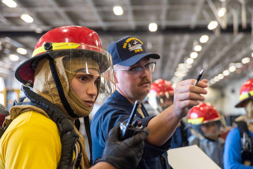 USS Ronald Reagan (CVN 76) Sailors conduct training during a general quarters drill