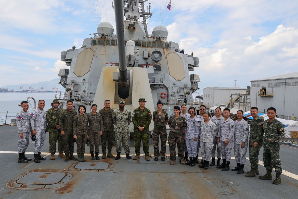 Military personnel from participating nations attend a medical presentation aboard the USS Howard during Sama Sama 2024