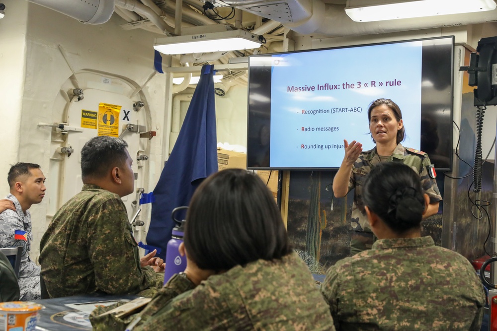 Military personnel from participating nations attend a medical presentation aboard the USS Howard during Sama Sama 2024