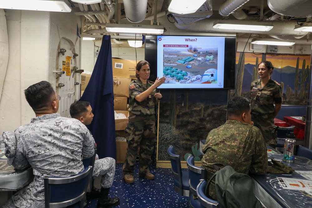 Military personnel from participating nations attend a medical presentation aboard the USS Howard during Sama Sama 2024