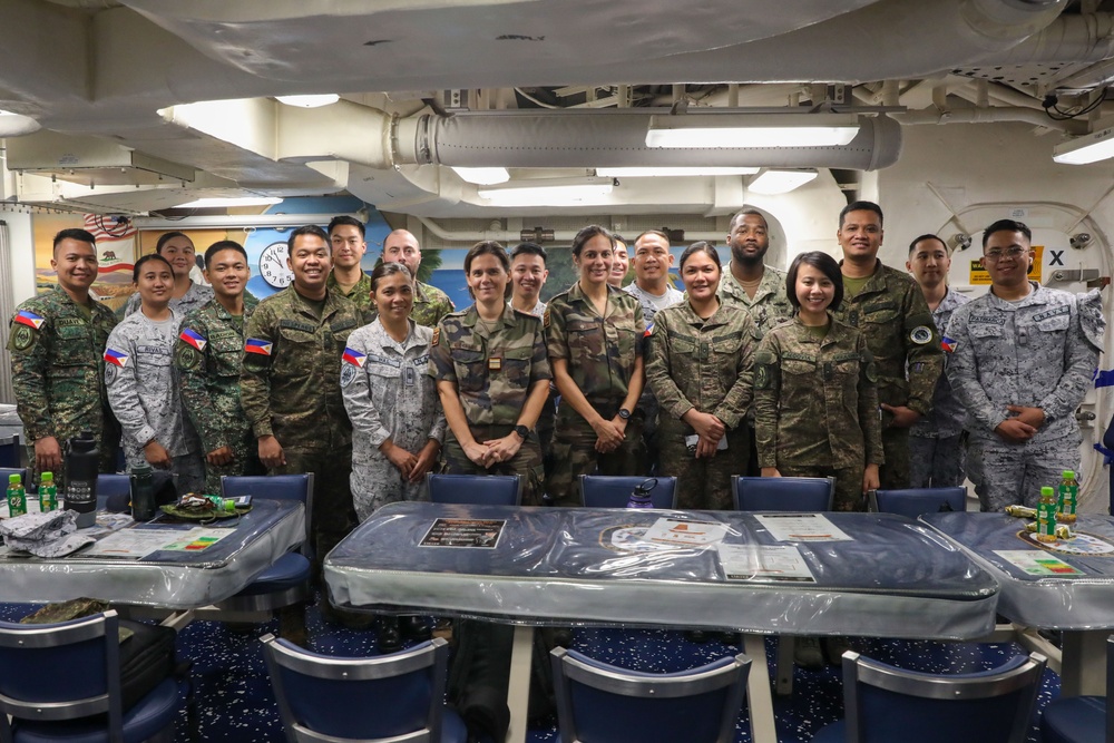 Military personnel from participating nations attend a medical presentation aboard the USS Howard during Sama Sama 2024