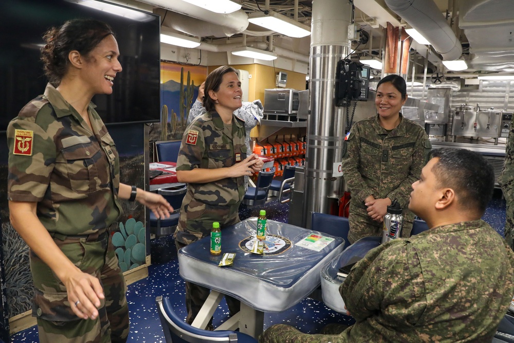 Military personnel from participating nations attend a medical presentation aboard the USS Howard during Sama Sama 2024