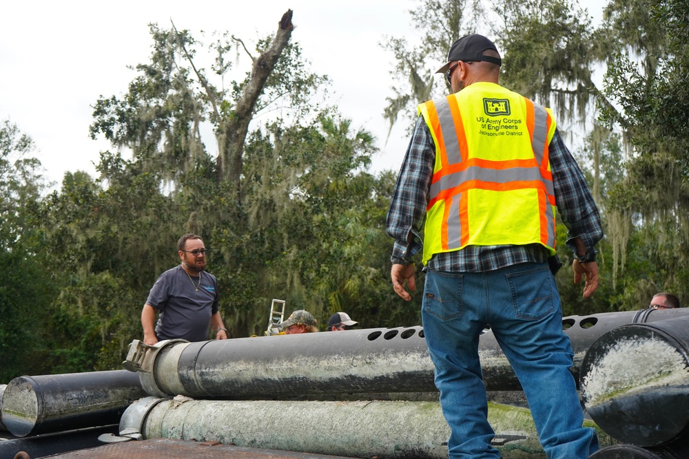 U.S. Army Corps of Engineers and South Florida Water Management work tirelessly to set up a pump system at Medard Reservoir to aid the flow of water to prevent flooding following Hurricane Milton on Oct. 10, 2024.