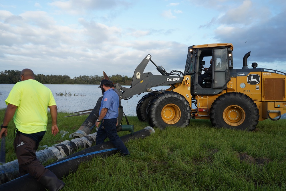 U.S. Army Corps of Engineers and South Florida Water Management work tirelessly to set up a pump system at Medard Reservoir to aid the flow of water to prevent flooding following Hurricane Milton on Oct. 10, 2024.
