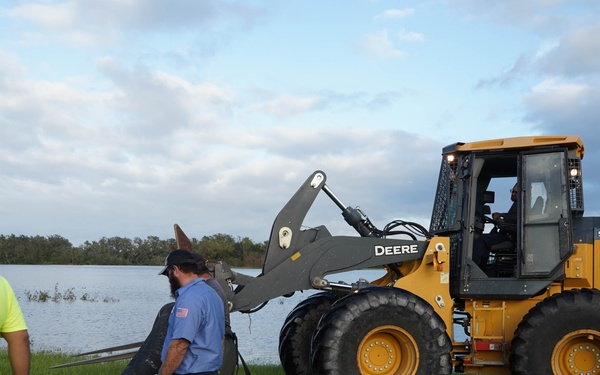 U.S. Army Corps of Engineers and South Florida Water Management work tirelessly to set up a pump system at Medard Reservoir to aid the flow of water to prevent flooding following Hurricane Milton on Oct. 10, 2024.